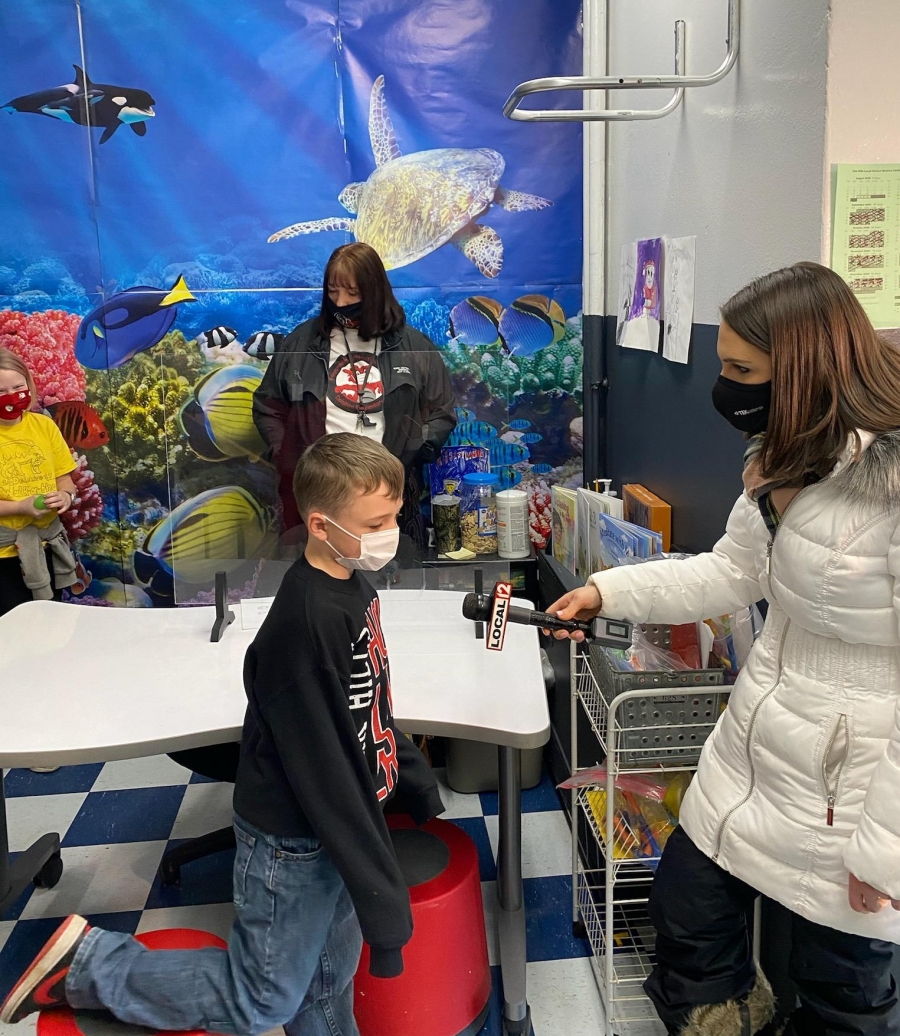 Reporter interviewing student